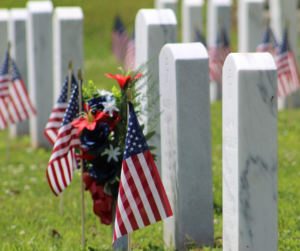American flags next to a row of tombstones